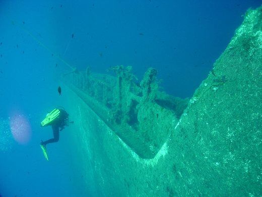 Divers exploring a shipwreck in the Mediterranean