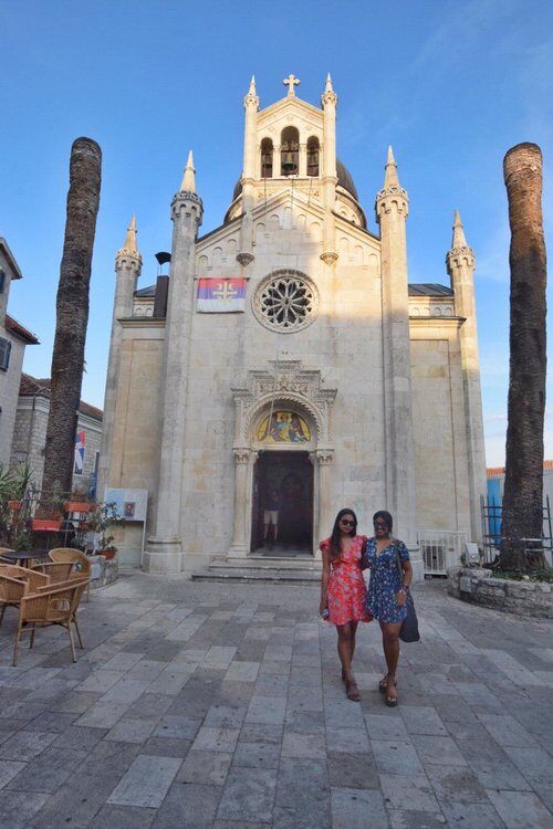 Travellers visiting a Mediterranean church, respectfully dressed